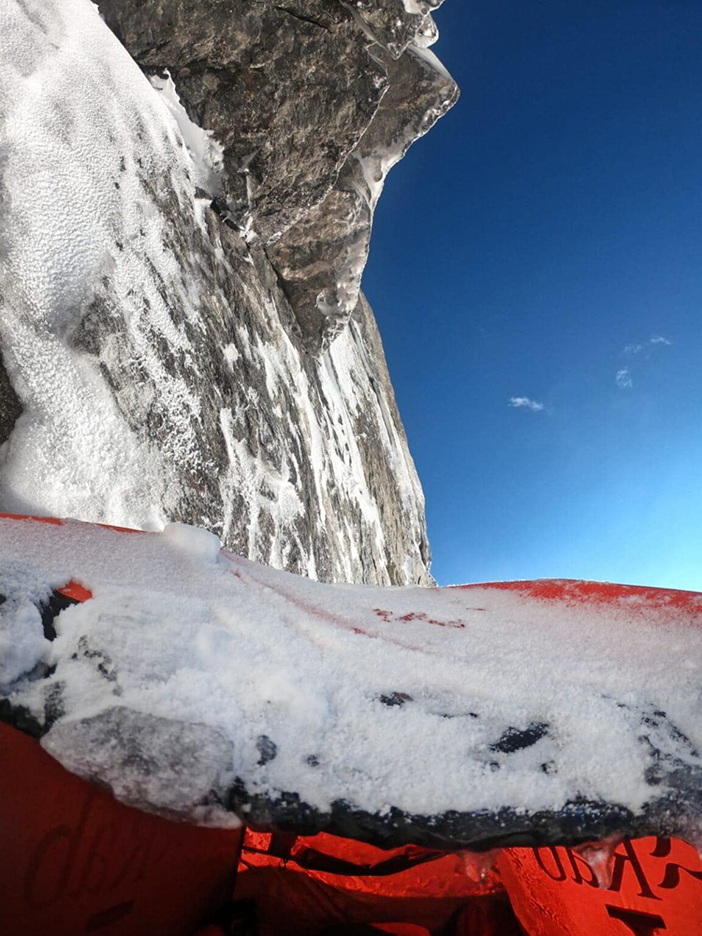 a rocky roof as seen from the gate of a snow-powederd tent gate