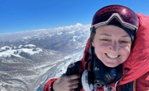 Tracee Metcalfe smiling on mountaontop