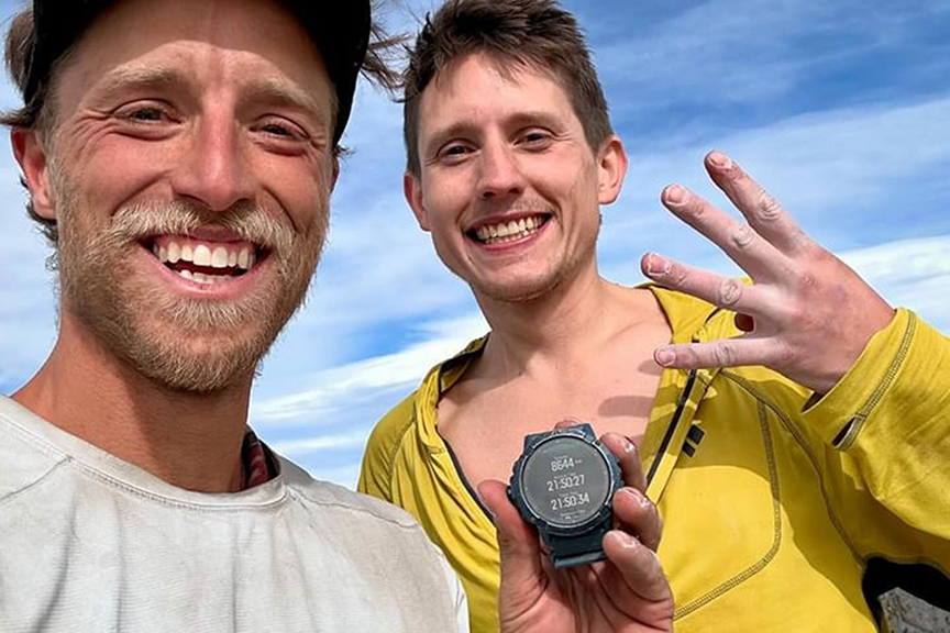 two climbers smile after their feat