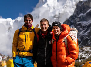 the climbers smile while standing in front of Jannu