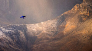 a man flies a wingsuit with a foil attached