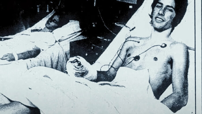 a young man in a hospital bed