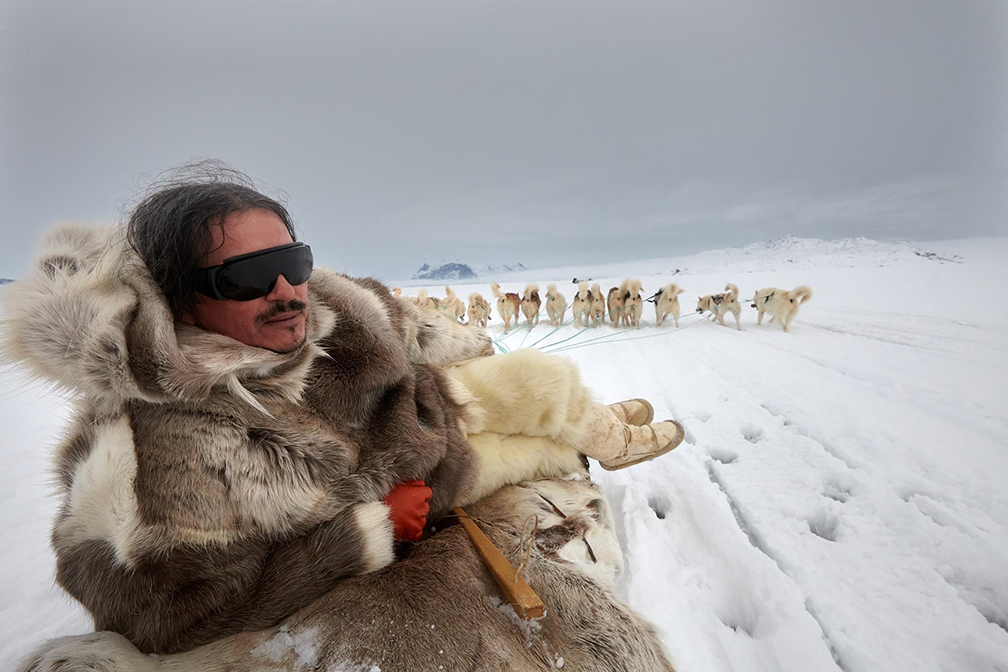 Greenland dogsledder in traditional clothing