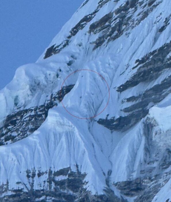 Two dots on the shadowy west face of Ama Dablam