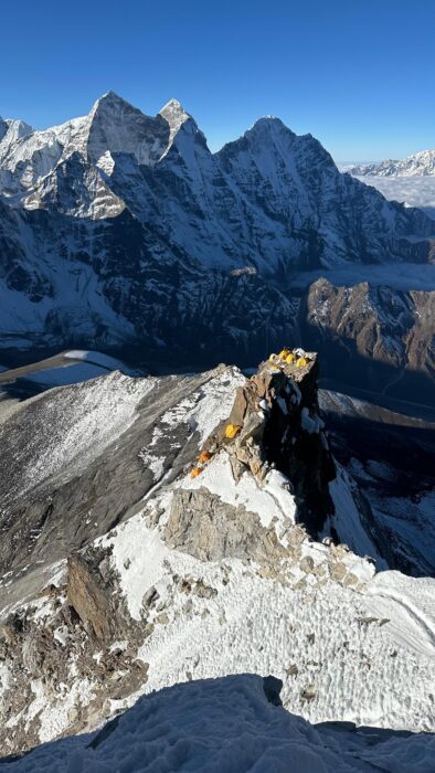 tents of Camp 1 on a rocky outcrop of Ama Dablam