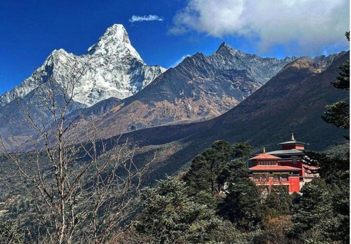 A landscape of mountains beyond a monastery, with Ama Dablam outstanding.