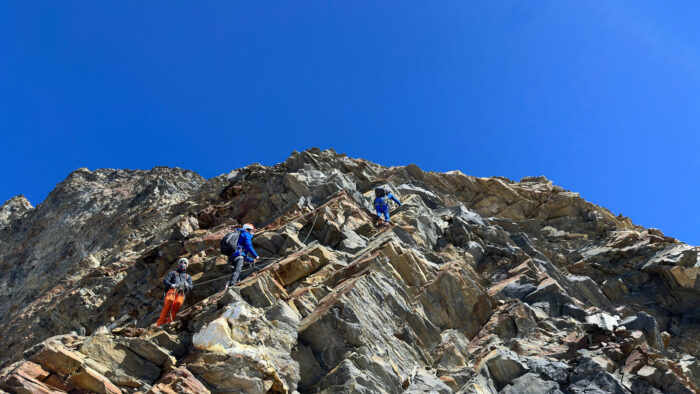 climbers on a ridge of brittle rock