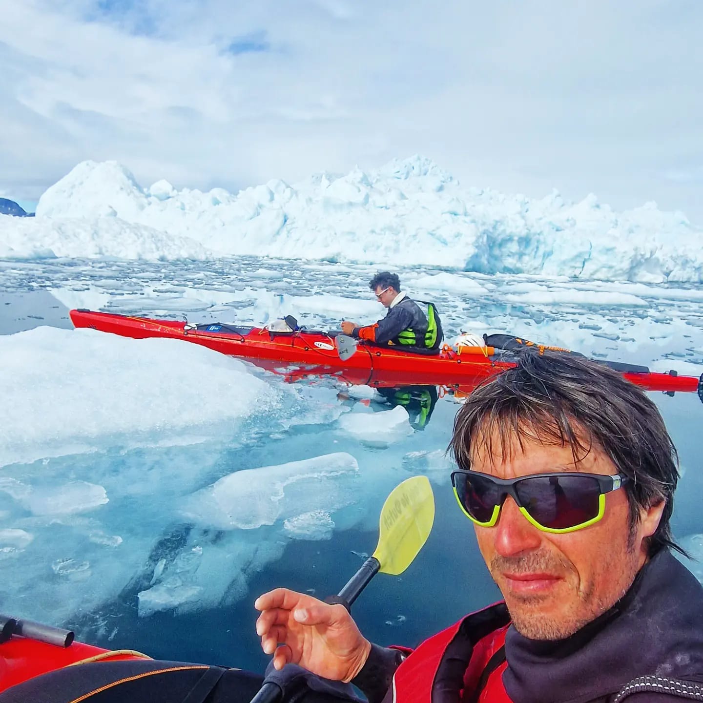 arctic kayaking in red kayaks