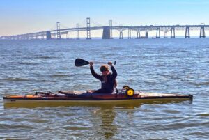 canoeist with bridge in background