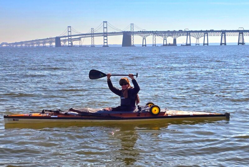 canoeist with bridge in background