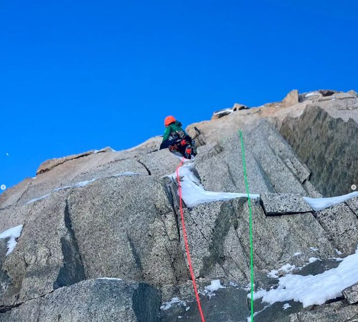 a climber on a mixed route on granite slabs