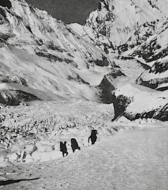 old b/w photo of Gangapurna with 3 climbers near an icefall