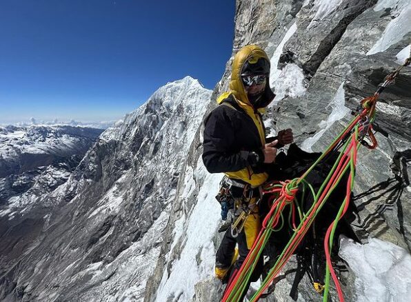 A Climber at a belay on arock-mixed face of Kingshung, Langtang.