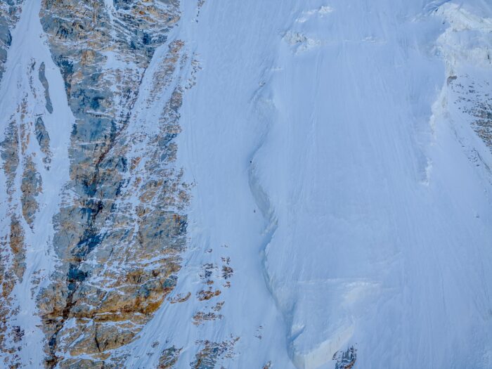 an ice face with the climbers spottd as two tiny dots on it