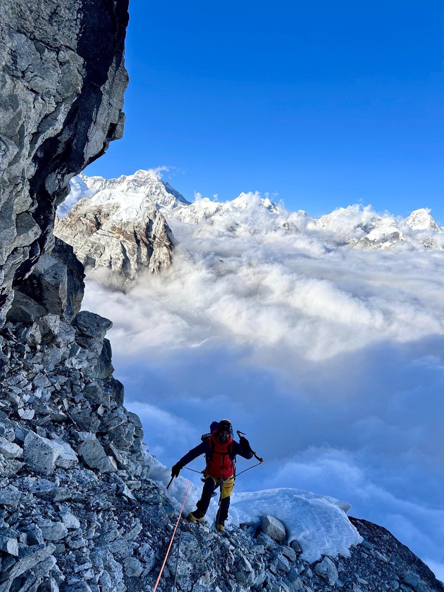 A climber above a sea of clouds on Kiajo Ri