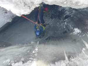 A Nepalese resucers rappels into an ice crevasse