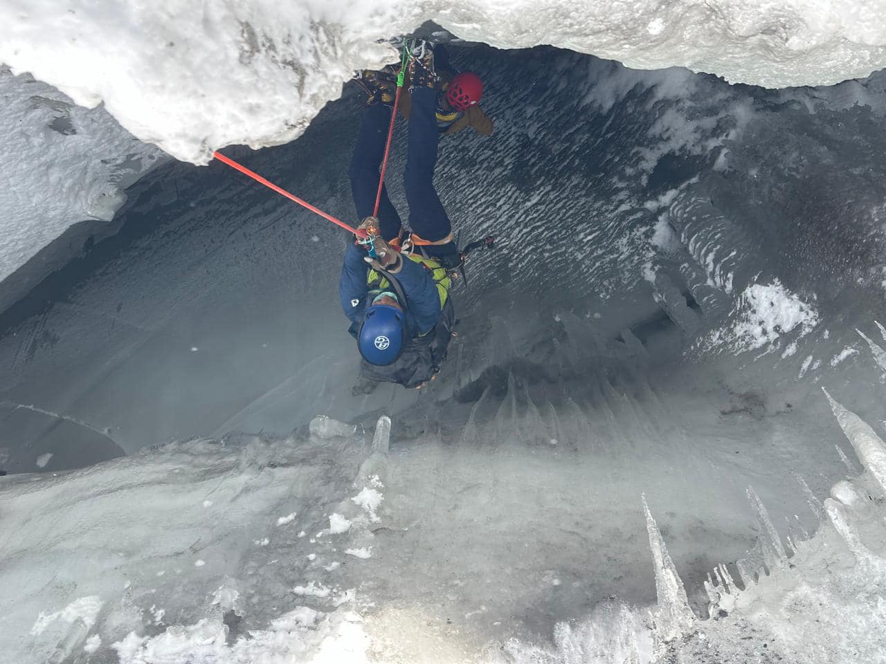 A Nepalese resucers rappels into an ice crevasse