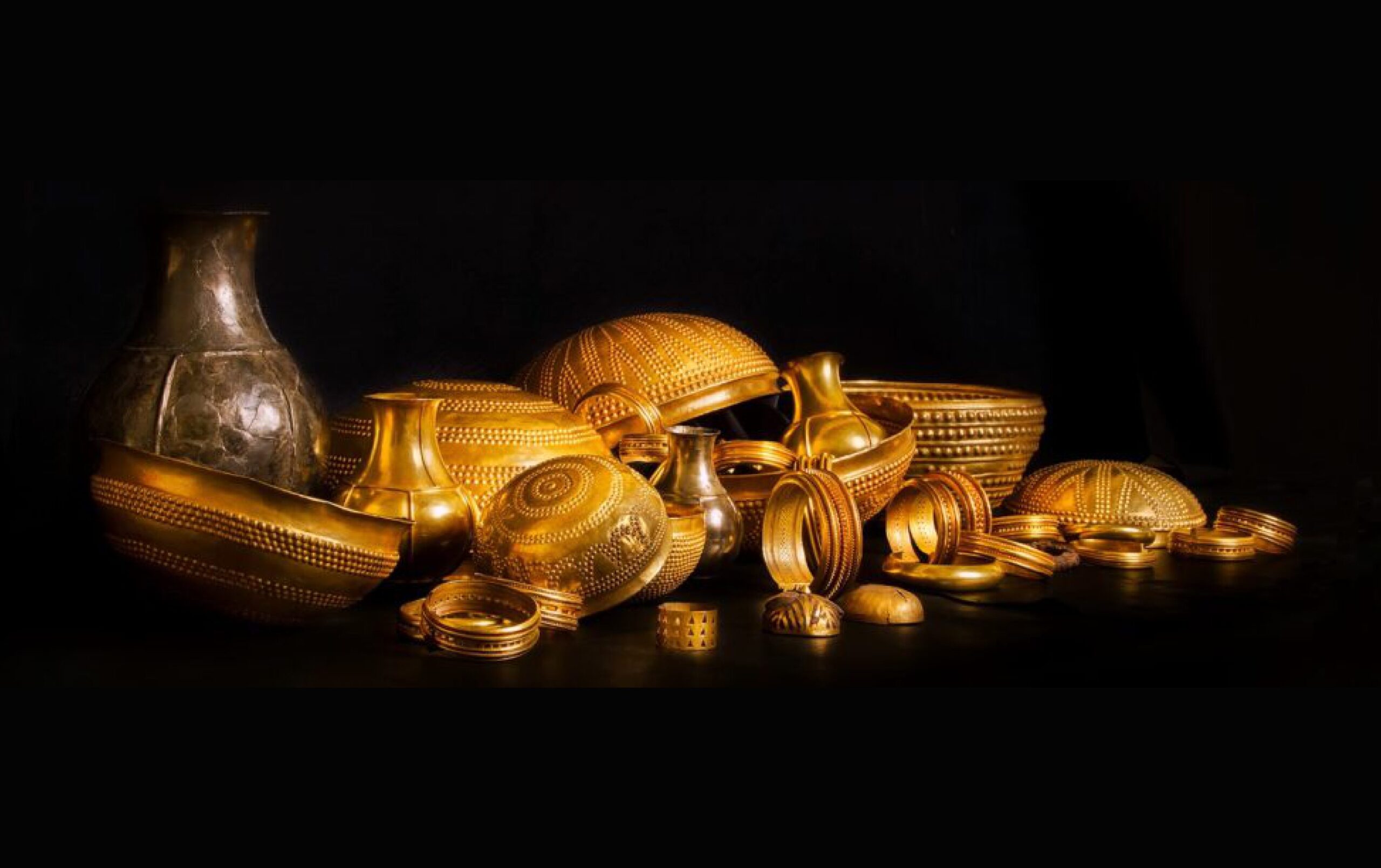 A collection of golden objects on a black background.