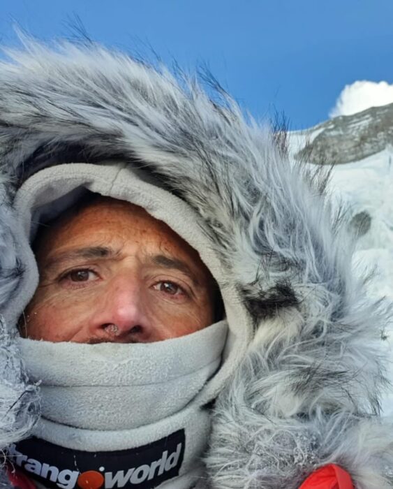 Txikon takes a selfie with a fur-rimmed hood and thick scarf covering his mouth.