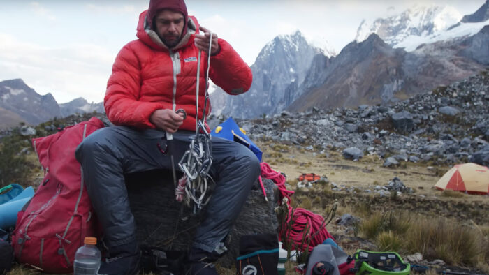 a man sorts climbing gear