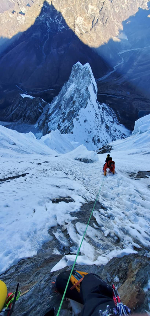 a climber on a steep ramp of thin ice