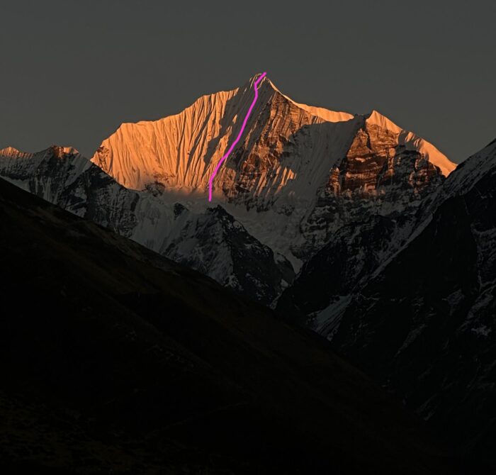 The route marked in purple on a photo of Ganchenpo at sunset. 