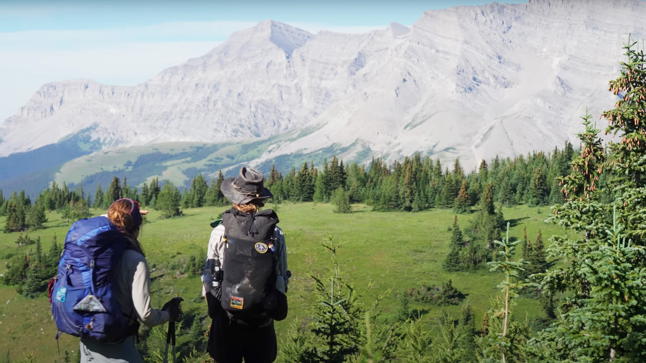 two people stare at a mountain view