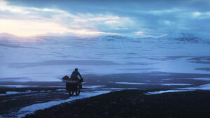 a man cycles across a frozen landscape