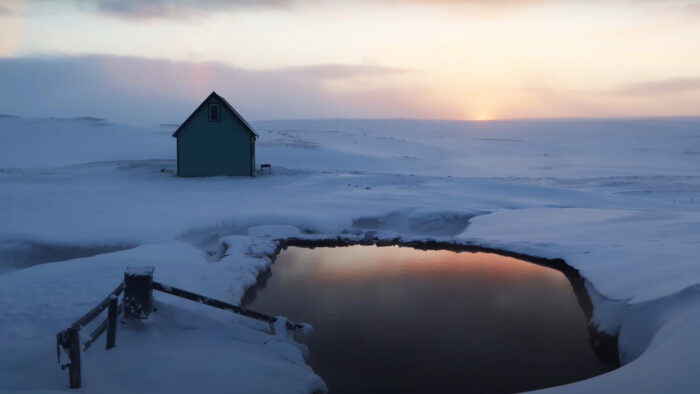 a winter hut at sunset