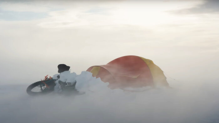 a bike and tent pummeled by the wind