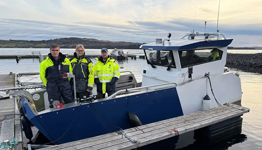 Three researchers on a small boat.