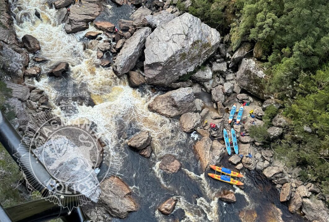 An aerial shot of the river location, with kayaks on shore.