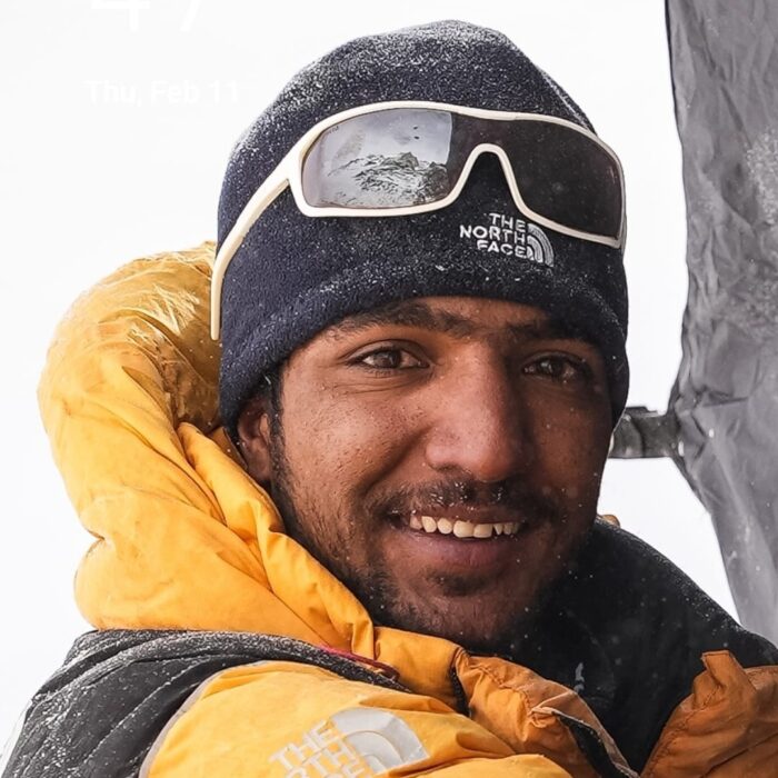 Close shot of Sajid Sadpara with a yellow dawn jacket and black beanie. 