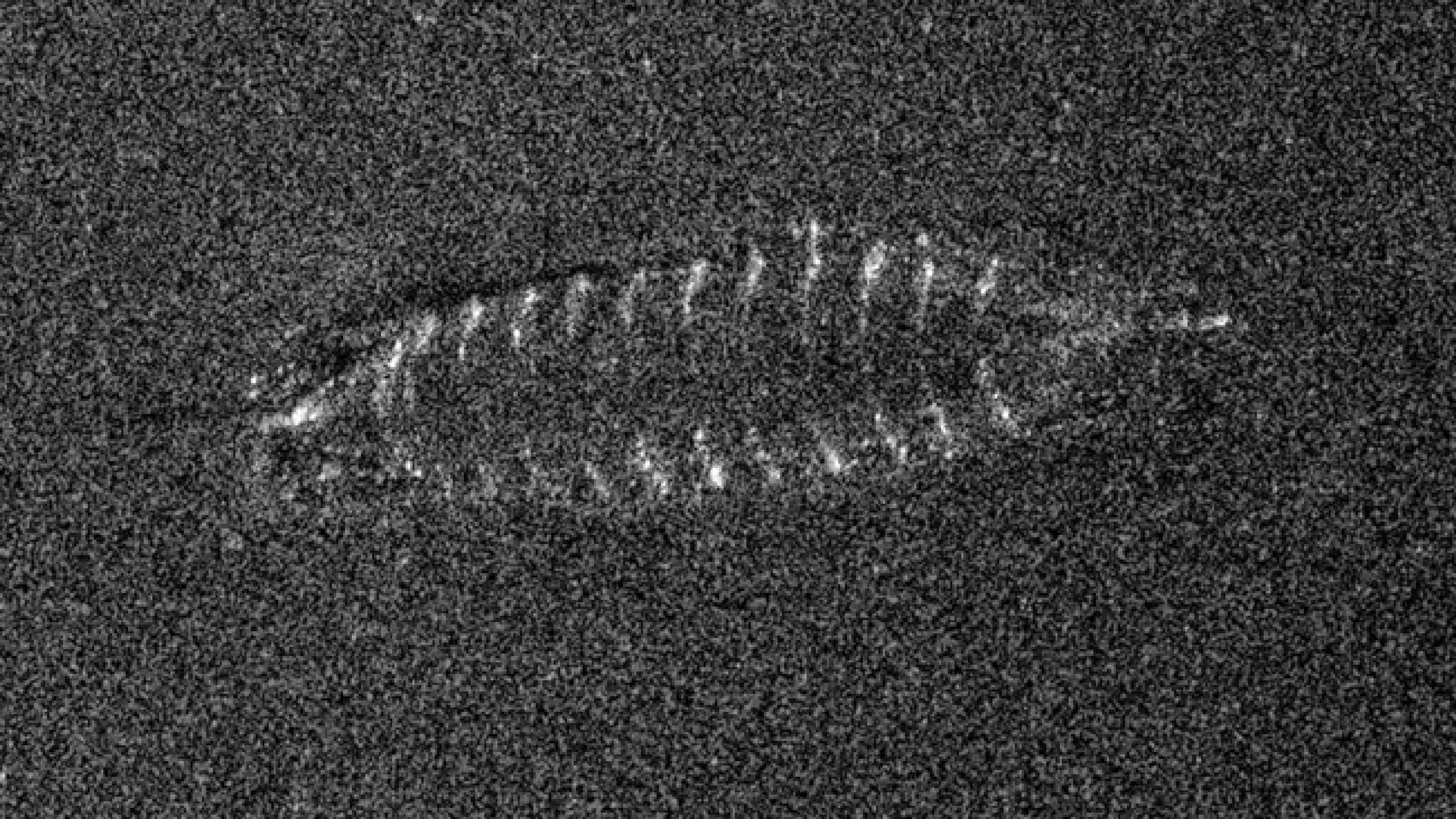 A grainy black and white sonar image of the vessel.