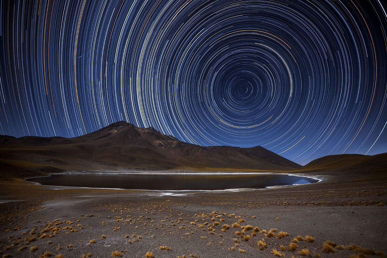 Stars appear to smear in the sky over a desert.