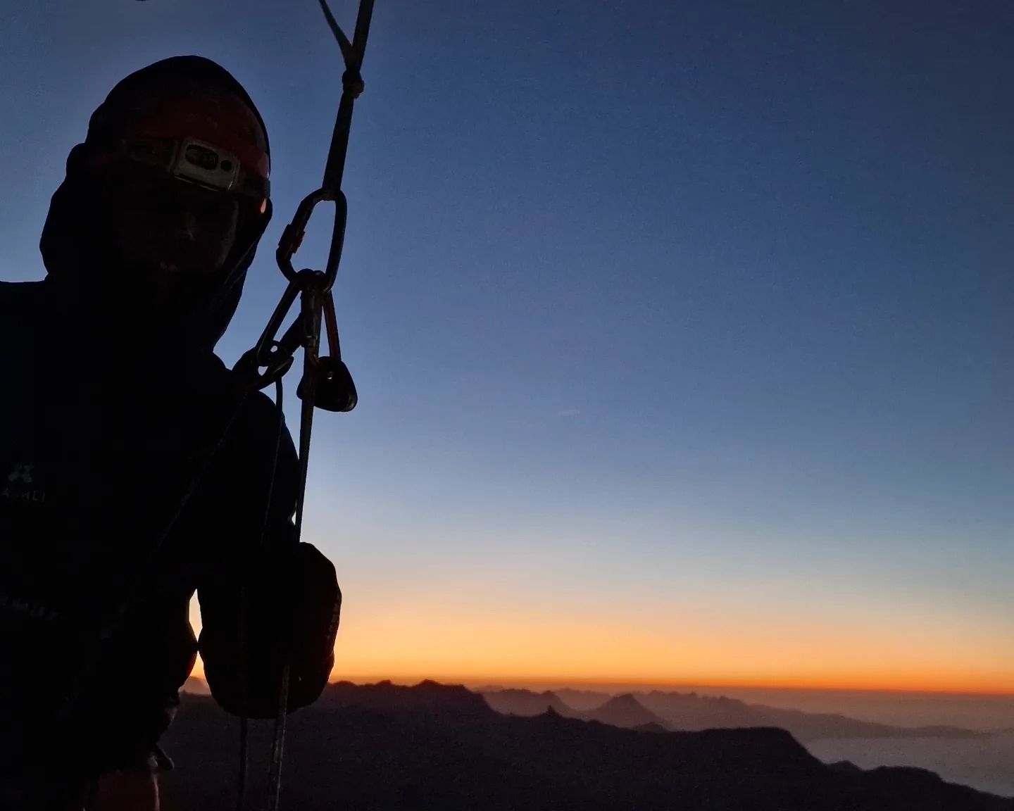 The shadow of Jonas Schild at sunrising on the north face of Eiger