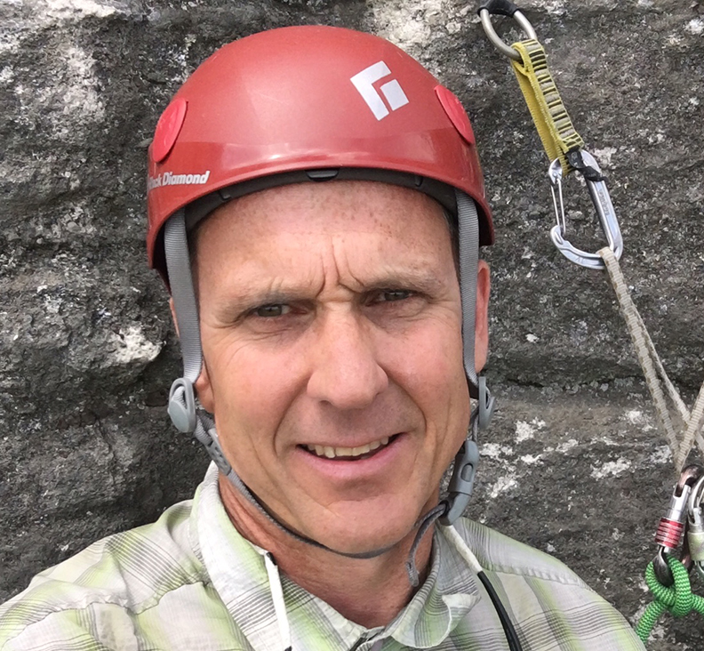 portrait of middle-aged climber in helmet