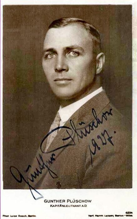 a german man poses for a black and white photograph