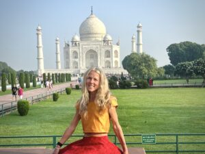 blonde woman in front of Taj Mahal