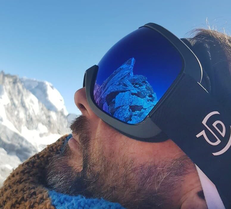 summit reflected in climber's goggles