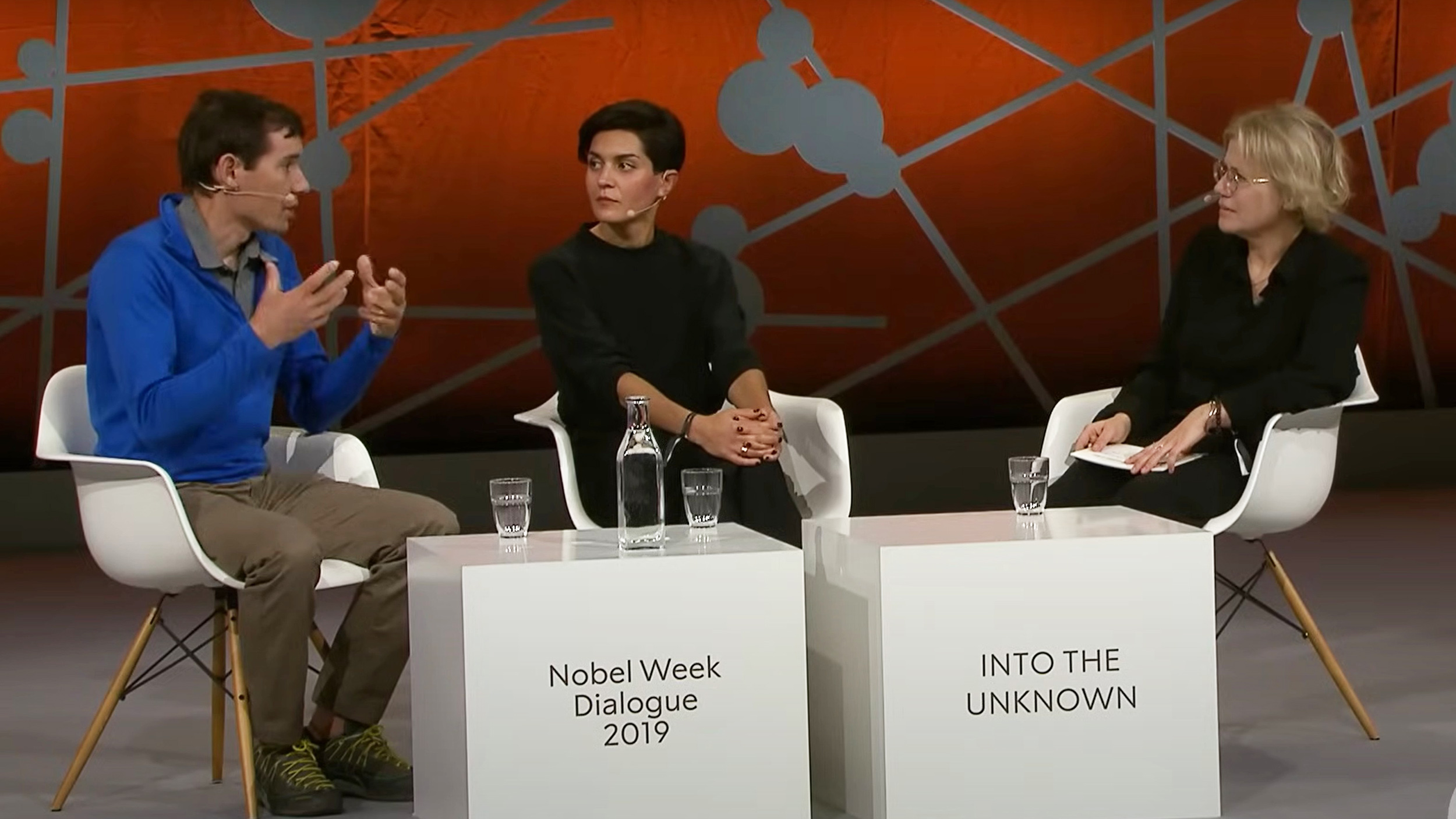 three people sitting on a stage