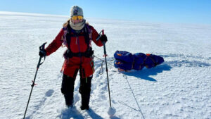 a woman on skis with a sled behind her