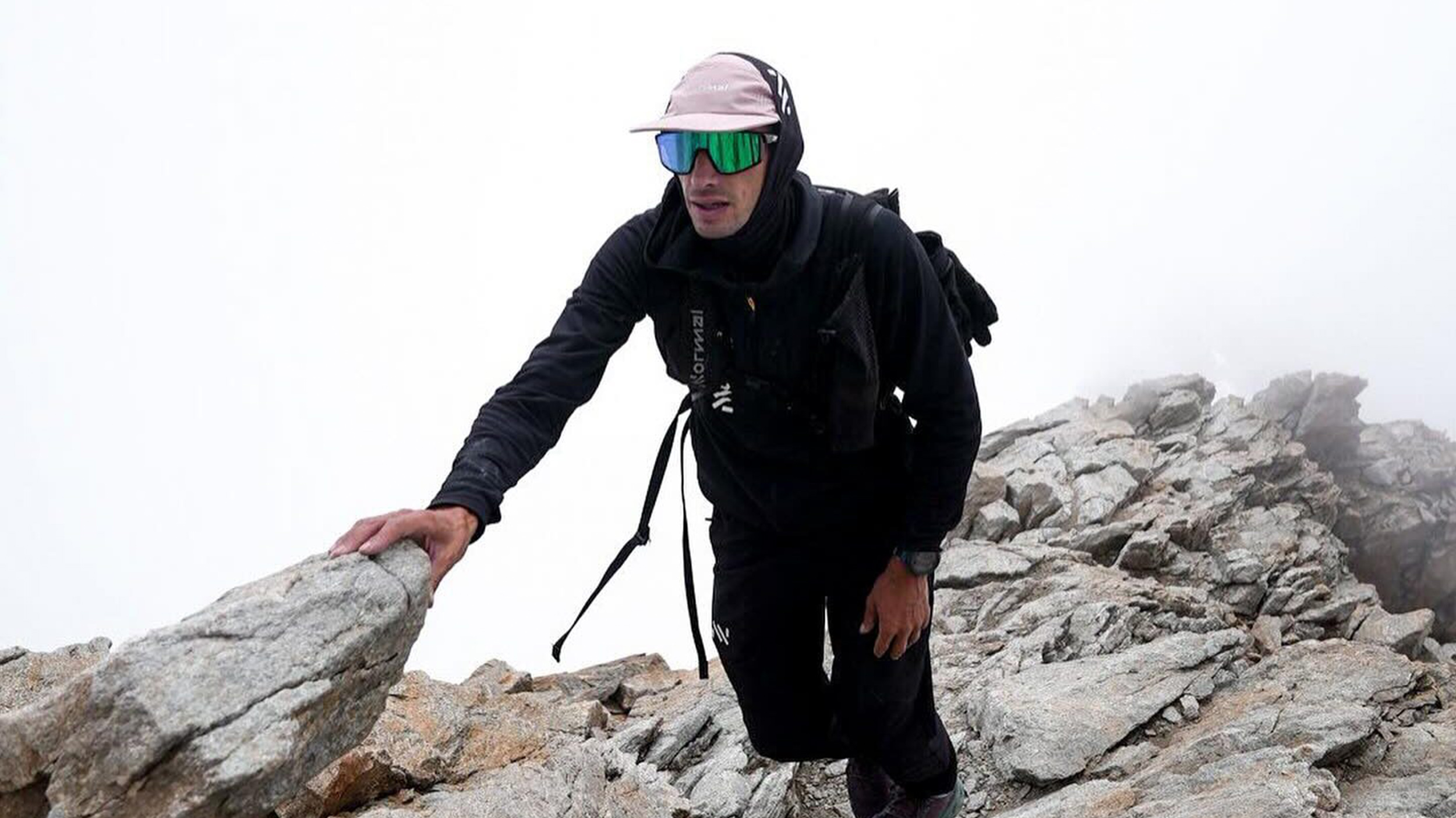 a man climbs a ridge