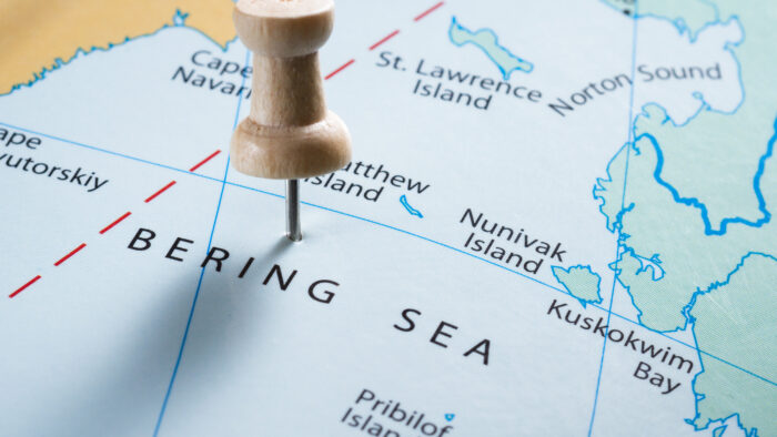 a map with a pin in the bering strait 