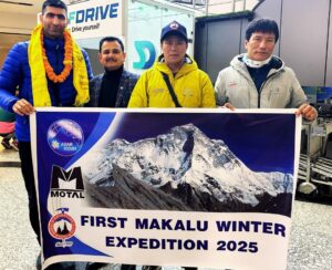 The climbers pose with an expedition banner at an airport lobby.