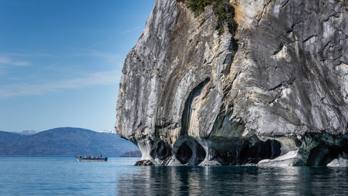 a lake with a cave system visible above the waterline 