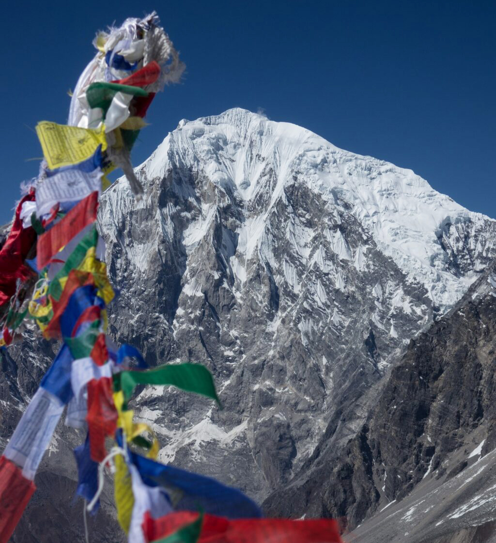 mountain face with prayer flags in foreground