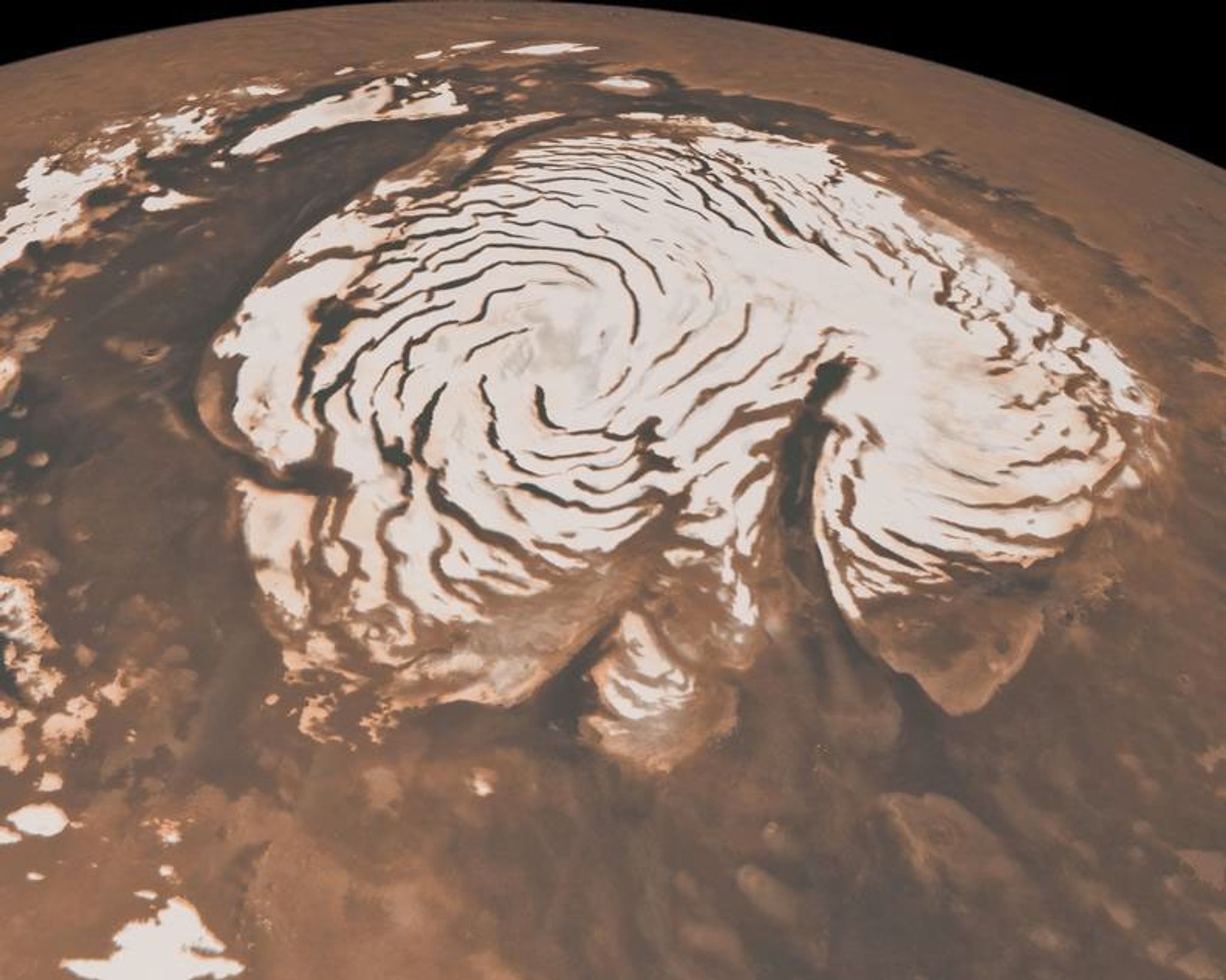 A circular polar ice sheet has concentric swirls in it.