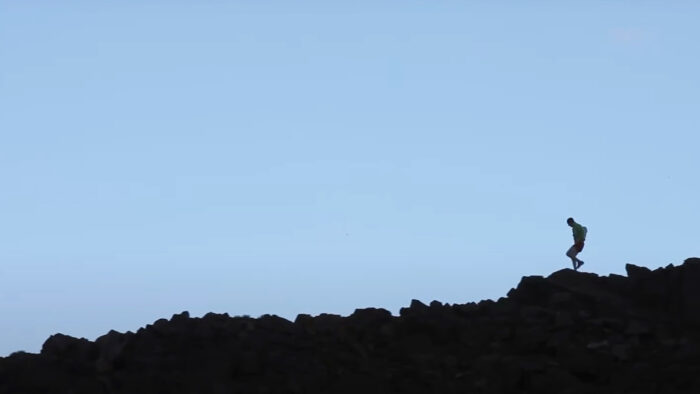 a runner on a mountain ridgeline 