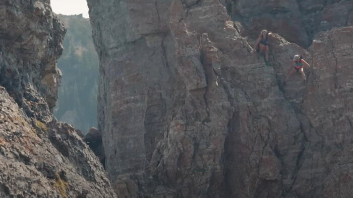 two women descend a treacherous scramble